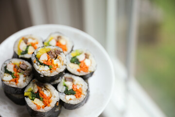 Kimbap is a traditional Korean dish made of rice, vegetables, and meat or seafood rolled in seaweed. It represents the country's rich culinary heritage and cultural diversity