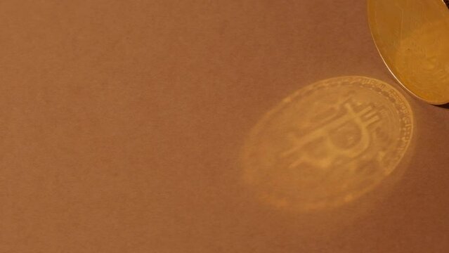 Bitcoin gold coin shadow reflection. Bitcoin mining trading concept. BTC golden money spinning around. Worldwide virtual internet Cryptocurrency or crypto digital payment system. Digital coin money