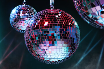 Bright shiny disco balls on dark background