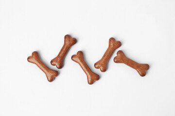 Bone shaped dog cookies on white background, flat lay