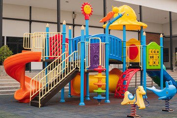 Children playground on yard activities in the school.Outdoor play equipment for kindergarten children.Children run, slide, swing,seesaw on modern playground.Colorful playground on yard in the park.