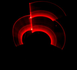 Fototapeta na wymiar Red light painting, long exposure photography, ripples and round pattern