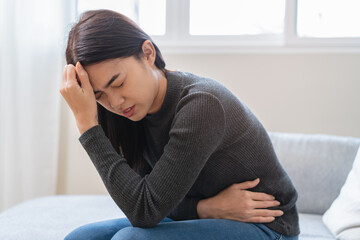 close up woman suffering stomach pain from food poisoning.