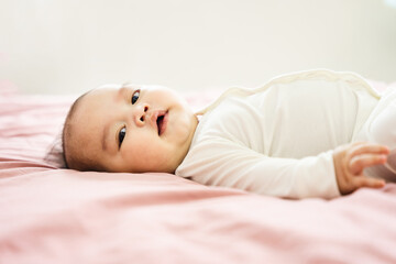 Obraz na płótnie Canvas image of a newborn baby lying on a pink bed