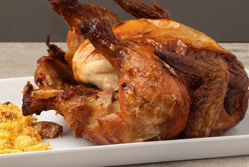 Roasted chicken with fried manioc flour.