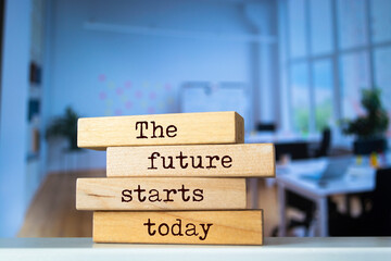 Wooden blocks with words 'The future starts today'.