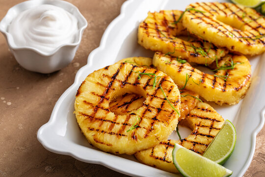 Grilled pineapple with lime honey glaze and whipped cream
