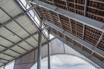Ceilings, roofs, pillars, and the steel construction of a building. Modern architectural design of an hall building daylight during the day.
