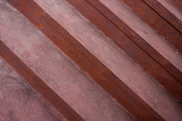 Red cement steps in the city Closeup concrete staircase with railing, old staircase detail, abstract stone staircase background.