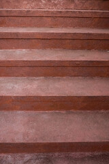 Red cement steps in the city Closeup concrete staircase with railing, old staircase detail, abstract stone staircase background.