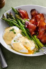 Healthy breakfast with poached eggs, bacon and asparagus