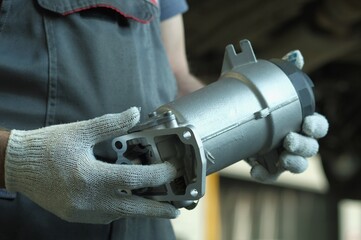 Fuel filter for diesel engine. Close-up. During the preparation for the replacement, the car mechanic inspects the new fuel filter, monitors the compliance and integrity of the spare part.