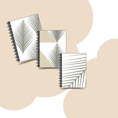 Three notebooks on a delicate pale peach background.
