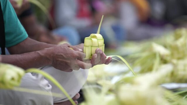 The process of making "Ketupat" nests on the sidewalk of Jalan Kotagede, Yogyakarta. Ketupat is a typical Eid food.