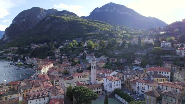 Cinematic aerial view of Menaggio Italian medieval village at sunset. Lake Como tourism
