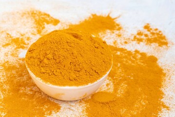 Turmeric Powder in a White Bowl Isolated on White Background with Copy Space