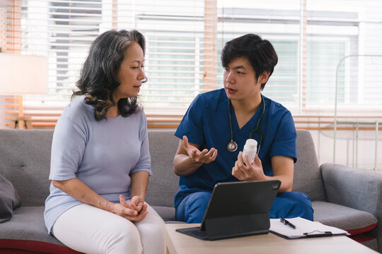 Health Visitor And A Senior Woman With Tablet During Home Visit. Elderly Healthcare And Home Health Care Service Concept