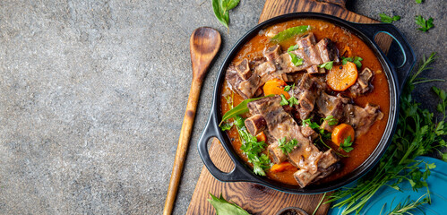Beef ribs Bourguignon. Beef ribs stewed with carrot, onion in red wine. France dish - obrazy, fototapety, plakaty