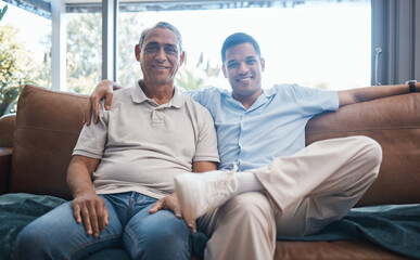 Portrait of happy man with senior father on sofa, happiness and quality time together in living...