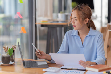 Businesswoman working in the office with paper files Data graph document to find and review cleared tasks still backlog. unsuccessful folder documents at office desk.