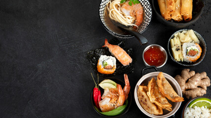 Traditional Japanese food dishes on black background, top view, copy space