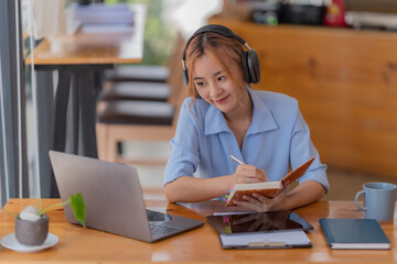 Young student who learns with online platform at coffee shop or co-working space 