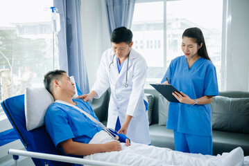 Hospital Ward Male and  Male Professional Asian Doctors Talk with a Patient, Give Health Care Advice, Recommend Treatment Plan  with Advanced Equipment