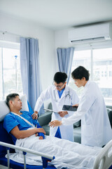 Hospital Ward Male and  Male Professional Asian Doctors Talk with a Patient, Give Health Care Advice, Recommend Treatment Plan  with Advanced Equipment