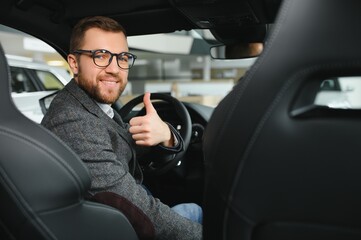 Handsome male taxi driver in car.