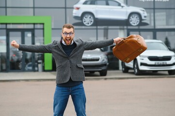 Portrait of happy customer buying new car.