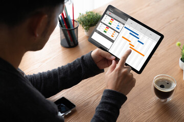 Project planning software for modish business project management on the computer screen showing...