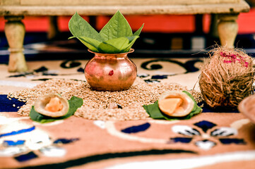 Pot with betel leaf and coconut and wheat seeds for hindu engagement ceremony worship. Wedding...