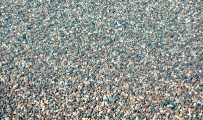 Stone pebbles on the shore as an abstract background. Texture.