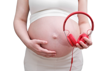 Headphones for listening to music in the hands of a pregnant woman, a studio shot, isolated on a white background