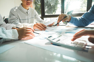 Businessmen working together at desk.