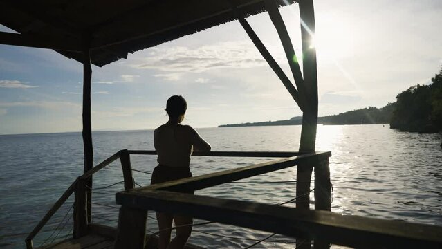 Slow motion silhouette shot of a tourist enjoying the views of the ocean in Bohol