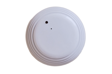 Smoke detector of fire alarm, the white background of the wall, isolated on a white background. Sensor on beige ceiling, isolated on a white background. Smoke fire alarm in the inactive state.