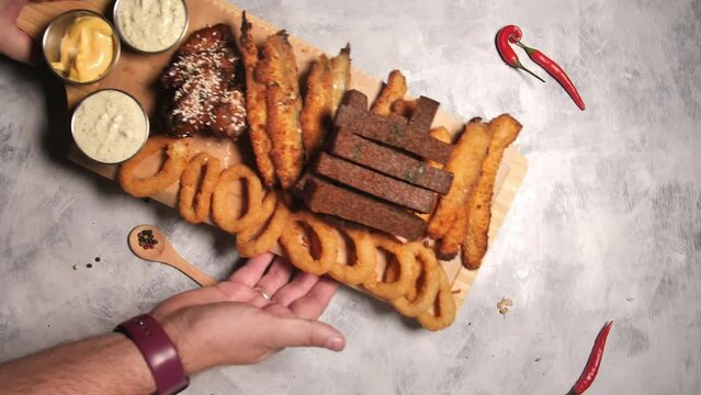 Tasty beer snacks on a wooden plate.Crispy toasted bread croutons. A pile of hard rusks from dark dry bread close up. Snack for beer.