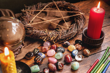 Runestones on red napkin. Divination items. Runes, crystal ball, pentacle symbol, herbal twist of...