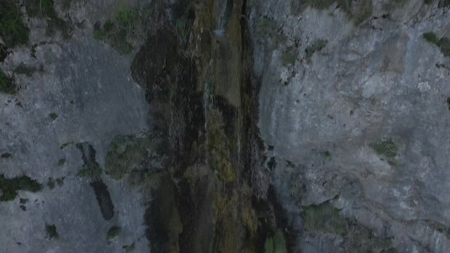 Drone footage over a waterfall inside the beatiful gorge of Frasassi, Italy