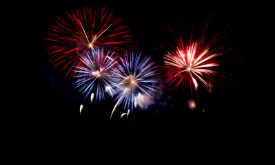 Fototapeta premium Red, white, and blue fireworks light up the night sky, patriotic celebration, New Years Eve or Independence Day. Shallow depth of field, Illustrative Generative AI