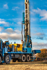 The drilling rig close up. Powerful drilling rig against a cloudy sky. Deep hole drilling. Geological exploration work. Mineral exploration. Extraction of gas and oil.