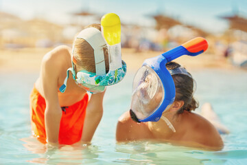 Picture of the mother and son in water in snorkeling mask
