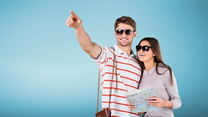 Happy couple of tourist posing on background.