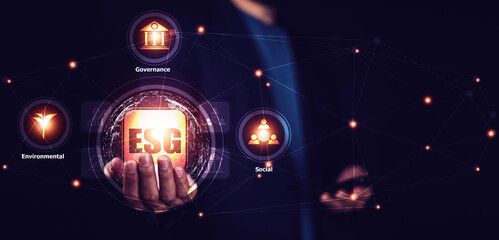Businessman Environment social and governance in sustainable ethical business. Hand holding crystal globe with network connection and ESG icons. Using technology of renewable resource