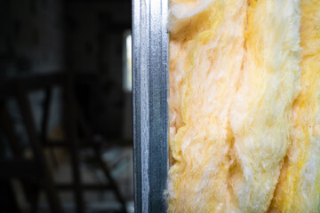 The partition is filled with glass wool close-up. Frame wall from a metal profile with mineral wool...