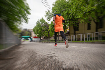 The runner accelerates before the finish line. Athletics competitions on city streets
