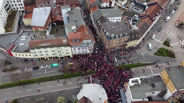 Aerial drone view of the FCK Kaiserslautern fans (  football match spectators ) crowding at a street intersection celebrating their win ( victory ) with beer in the old city of Kaiserslautern, Germany