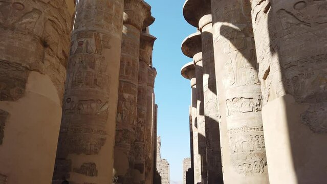 Hieroglyphs, carvings, inscriptions and symbols depicted on Papyrus columns Antique pillars of Great Hypostyle Hall in Karnak temple complex Luxor. Camera movement from top to bottom