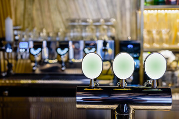 Closeup of tap chrome draft beer kegerator tower in bar